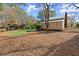 Charming backyard with trees, a white picket fence, and a separate outbuilding at 7865 Nesbit Ferry Rd, Sandy Springs, GA 30350