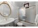 Elegant bathroom with frosted glass shower, pedestal sink, and decorative mirror at 7865 Nesbit Ferry Rd, Sandy Springs, GA 30350