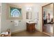 Bathroom with stained glass window, antique vanity, and wood floors at 7865 Nesbit Ferry Rd, Sandy Springs, GA 30350