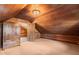 Rustic bedroom featuring wood-paneled walls and vaulted ceiling at 7865 Nesbit Ferry Rd, Sandy Springs, GA 30350