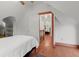 Bedroom with wood floors, sloped ceilings, and view to another room at 7865 Nesbit Ferry Rd, Sandy Springs, GA 30350