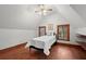 Cozy bedroom with hardwood floors, built-in shelving, and natural light at 7865 Nesbit Ferry Rd, Sandy Springs, GA 30350