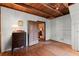 View of a bedroom with hardwood floors, white walls, and exposed beams at 7865 Nesbit Ferry Rd, Sandy Springs, GA 30350