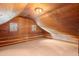 Charming bedroom with wood paneling, built-in seating, and vaulted ceiling at 7865 Nesbit Ferry Rd, Sandy Springs, GA 30350