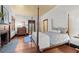 Charming bedroom with four-poster bed, fireplace, and wood floors at 7865 Nesbit Ferry Rd, Sandy Springs, GA 30350