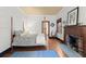 Main bedroom with a fireplace, hardwood floors, and a four-poster bed at 7865 Nesbit Ferry Rd, Sandy Springs, GA 30350
