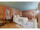 Rustic bedroom with wood-paneled walls, hardwood floors, and ample natural light at 7865 Nesbit Ferry Rd, Sandy Springs, GA 30350