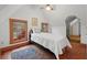 Bright bedroom with wood floors, sloped ceilings, and ample natural light at 7865 Nesbit Ferry Rd, Sandy Springs, GA 30350