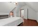 Cozy bedroom with hardwood floors, built-in shelving, and adjacent closet at 7865 Nesbit Ferry Rd, Sandy Springs, GA 30350
