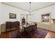 Charming dining room with hardwood floors, chandelier, and large windows at 7865 Nesbit Ferry Rd, Sandy Springs, GA 30350
