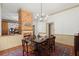 Dining room featuring a brick fireplace, hardwood floors, and unique decor at 7865 Nesbit Ferry Rd, Sandy Springs, GA 30350