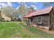 Rustic log cabin with a red metal roof and a grassy yard at 7865 Nesbit Ferry Rd, Sandy Springs, GA 30350