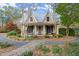 Charming home with a front porch, swing, and rocking chairs at 7865 Nesbit Ferry Rd, Sandy Springs, GA 30350