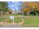 Two-story home with a front porch, landscaping, stone retaining wall, and a mailbox at 7865 Nesbit Ferry Rd, Sandy Springs, GA 30350