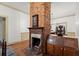 Brick fireplace with antique wooden mantel and built-in spice cabinet at 7865 Nesbit Ferry Rd, Sandy Springs, GA 30350