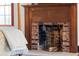 Close-up of a brick fireplace with wood mantle in a cozy bedroom at 7865 Nesbit Ferry Rd, Sandy Springs, GA 30350
