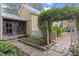 Stone pathway leading through a garden with a white picket fence and an archway at 7865 Nesbit Ferry Rd, Sandy Springs, GA 30350