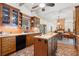 Spacious kitchen with island, exposed beams, and brick flooring at 7865 Nesbit Ferry Rd, Sandy Springs, GA 30350