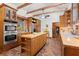 Kitchen with stainless steel appliances, large island, and brick floors at 7865 Nesbit Ferry Rd, Sandy Springs, GA 30350