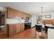 Simple kitchen with wood cabinets, black appliances, and a dining area at 7865 Nesbit Ferry Rd, Sandy Springs, GA 30350