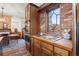 Kitchen features wood cabinetry, brick accent wall, and stainless steel appliances at 7865 Nesbit Ferry Rd, Sandy Springs, GA 30350