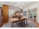 Kitchen and dining area with exposed beams, wood cabinets, and brick flooring at 7865 Nesbit Ferry Rd, Sandy Springs, GA 30350