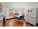 Bright kitchen featuring white cabinetry, a charming dining area, and hardwood floors at 7865 Nesbit Ferry Rd, Sandy Springs, GA 30350