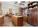 Kitchen island with sink, wood cabinets, and brick floors at 7865 Nesbit Ferry Rd, Sandy Springs, GA 30350