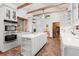 Bright kitchen with white cabinets, island, and brick flooring at 7865 Nesbit Ferry Rd, Sandy Springs, GA 30350