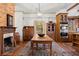 Open kitchen and dining area with fireplace, wood floors, and antique furniture at 7865 Nesbit Ferry Rd, Sandy Springs, GA 30350