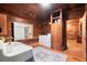 Laundry room with washer, dryer, vintage sink, wood paneling, and rustic accents at 7865 Nesbit Ferry Rd, Sandy Springs, GA 30350