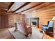 Rustic living room interior with log walls, exposed beams, and comfortable seating at 7865 Nesbit Ferry Rd, Sandy Springs, GA 30350
