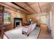 Cozy living room with a brick fireplace, wood-beamed ceiling, and hardwood floors at 7865 Nesbit Ferry Rd, Sandy Springs, GA 30350