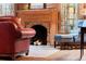 Living room fireplace with brick hearth and hardwood floors at 7865 Nesbit Ferry Rd, Sandy Springs, GA 30350