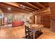 Rustic living room with exposed beams, hardwood floors, and a cozy fireplace at 7865 Nesbit Ferry Rd, Sandy Springs, GA 30350