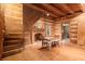 Rustic living area with fireplace, hardwood floors, exposed beams, and stairs at 7865 Nesbit Ferry Rd, Sandy Springs, GA 30350