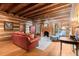 Cozy living room with wood-beamed ceiling, fireplace, and comfortable seating at 7865 Nesbit Ferry Rd, Sandy Springs, GA 30350