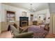 Cozy living room with fireplace, wood floors, and charming decor at 7865 Nesbit Ferry Rd, Sandy Springs, GA 30350