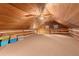 Spacious carpeted loft with wood-paneled ceiling and log walls at 7865 Nesbit Ferry Rd, Sandy Springs, GA 30350