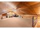Carpeted loft space with wood ceiling and partial log walls, perfect for an office at 7865 Nesbit Ferry Rd, Sandy Springs, GA 30350