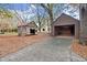 Two wooden outbuildings on a mulch-covered area at 7865 Nesbit Ferry Rd, Sandy Springs, GA 30350