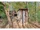 Rustic outhouse nestled among trees and bamboo at 7865 Nesbit Ferry Rd, Sandy Springs, GA 30350