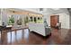 Sunroom with white sofa, backyard views through multiple windows, and unique patterned floor at 7865 Nesbit Ferry Rd, Sandy Springs, GA 30350