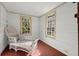 Cozy sunroom with wicker furniture, large windows, and wood floors at 7865 Nesbit Ferry Rd, Sandy Springs, GA 30350