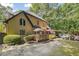 Backyard view of the home's exterior with deck, pool, and wooded area at 2505 Ridgehurst Dr, Buford, GA 30518