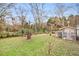 Expansive backyard with shed, trees, and grassy area at 8451 Duncan St, Douglasville, GA 30134