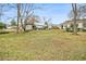 Large, grassy backyard with trees and storage buildings at 8451 Duncan St, Douglasville, GA 30134