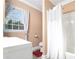 Bathroom with white vanity, shower/tub combo, and neutral-toned walls at 8451 Duncan St, Douglasville, GA 30134