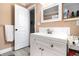 Bathroom featuring a white vanity, tiled backsplash, and wood-look tile flooring at 8451 Duncan St, Douglasville, GA 30134