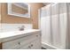 Clean bathroom with white vanity, shower, and tile backsplash at 8451 Duncan St, Douglasville, GA 30134